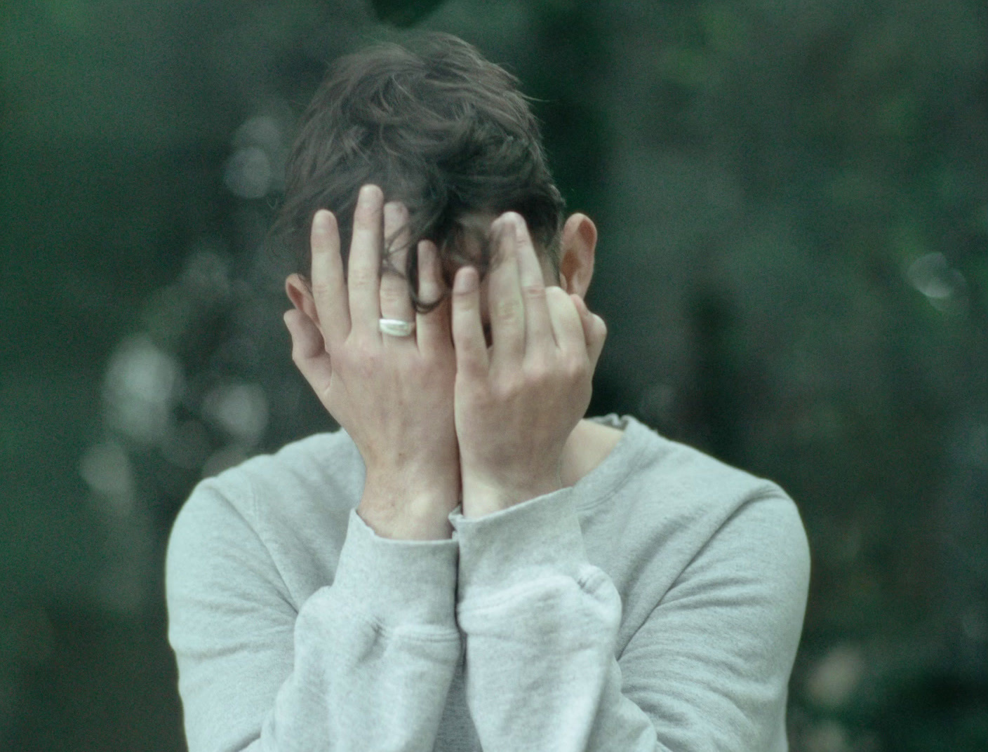 a woman covering her face with her hands