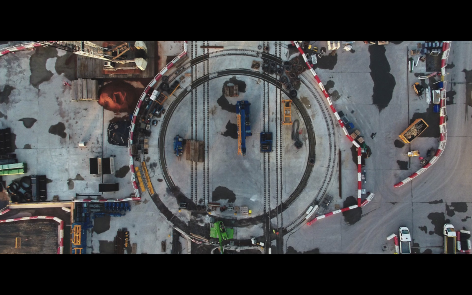 an aerial view of a train track and a parking lot