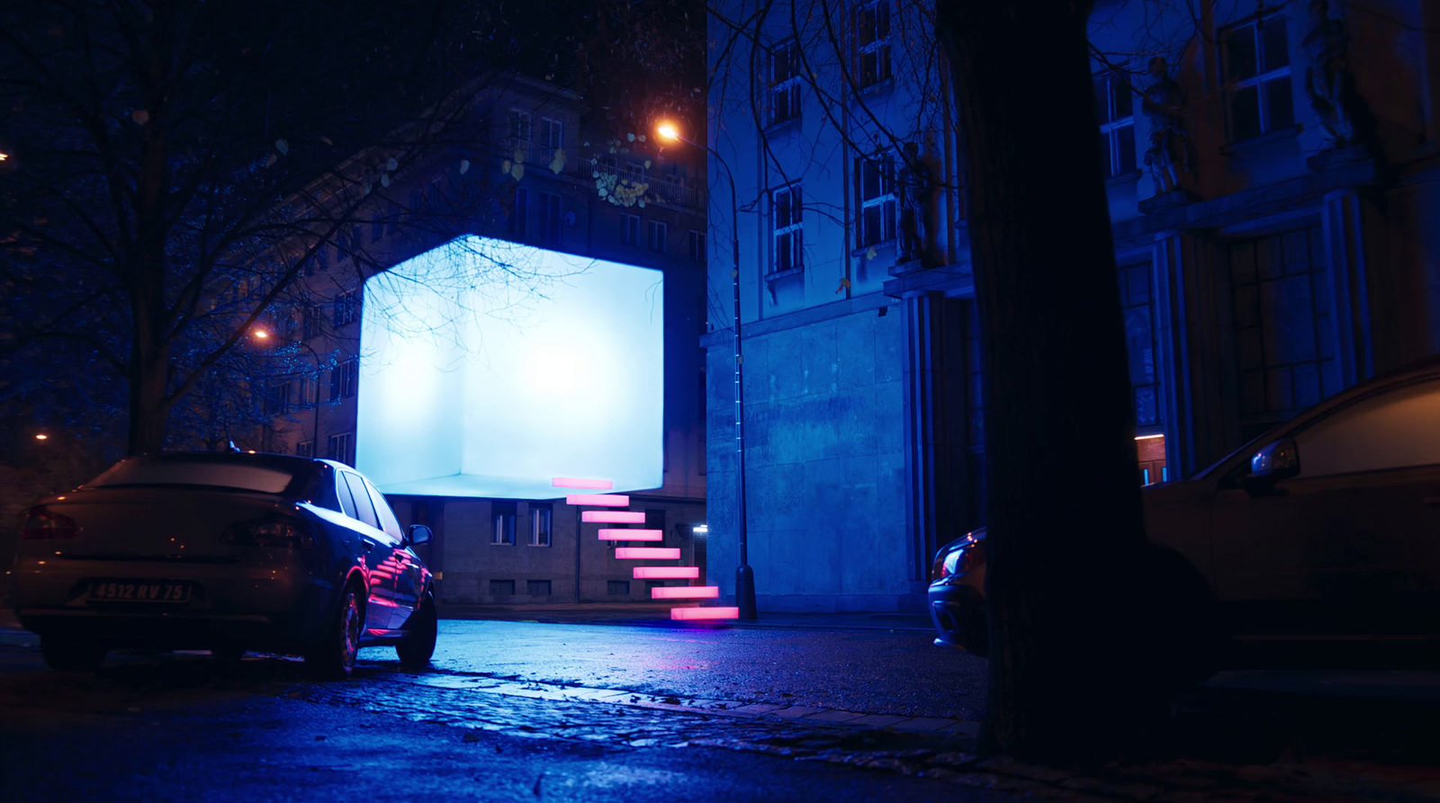 a car parked on the side of a street at night