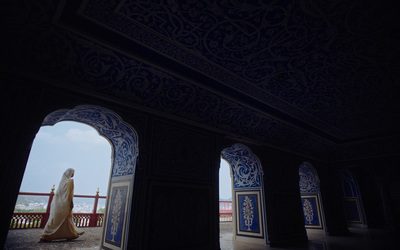 a woman in a white dress standing in an archway