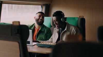 a couple of men sitting next to each other at a table