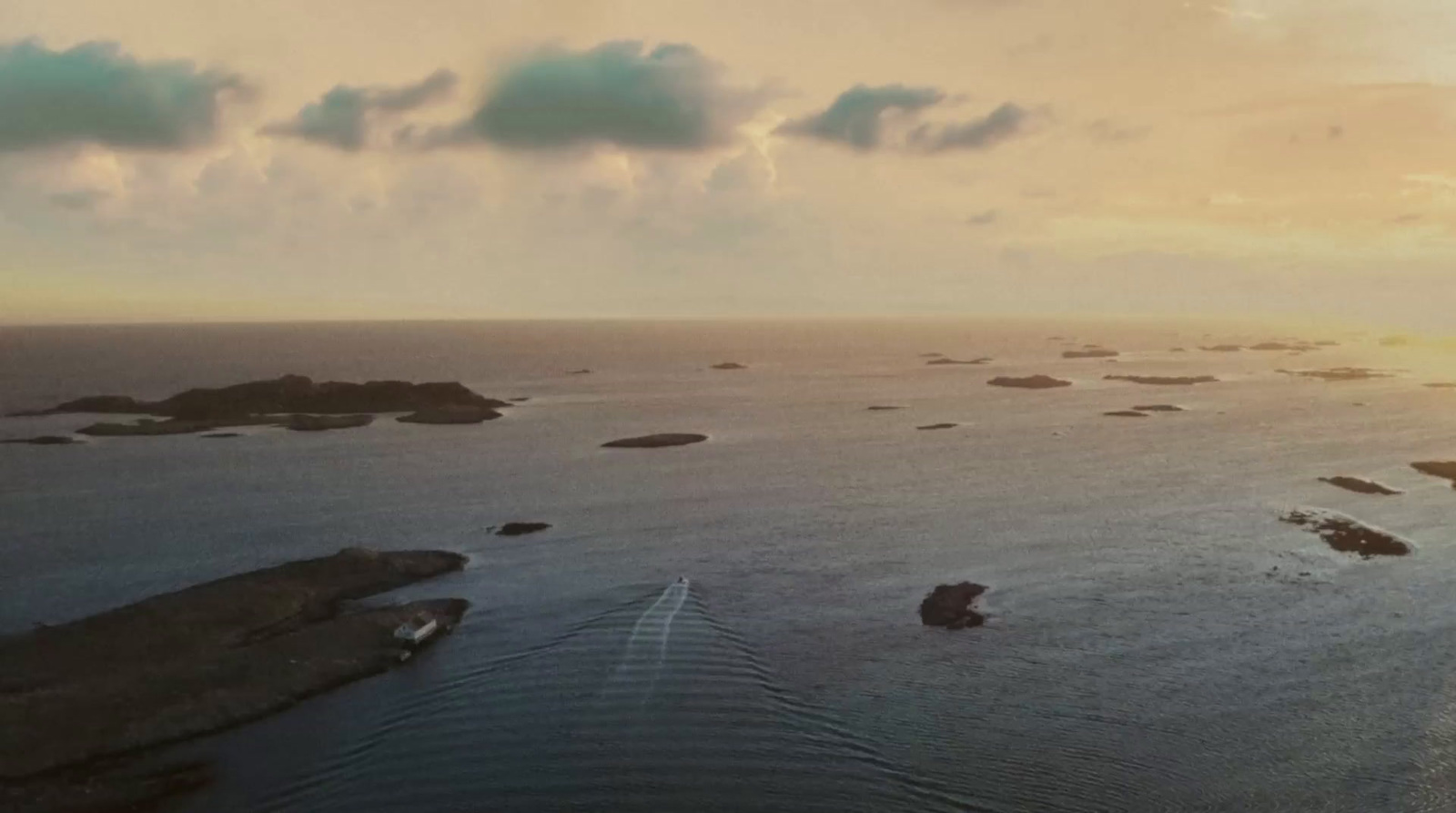 an aerial view of a body of water at sunset