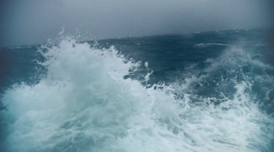 a person riding a surfboard on top of a wave