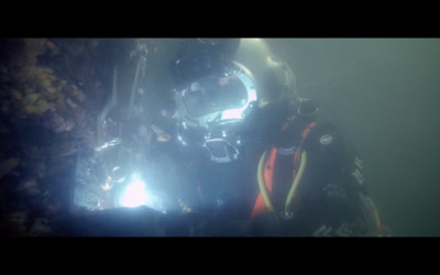 a person in a diving suit under water