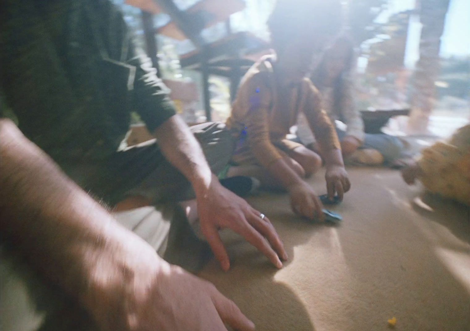 a group of people sitting on top of a wooden floor