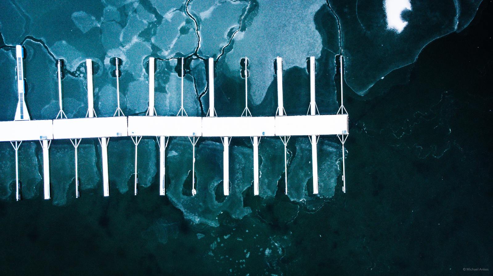 an aerial view of a dock with ice on it