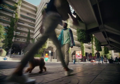 a man walking a dog down a street