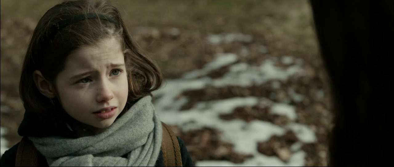 a young girl with a scarf around her neck