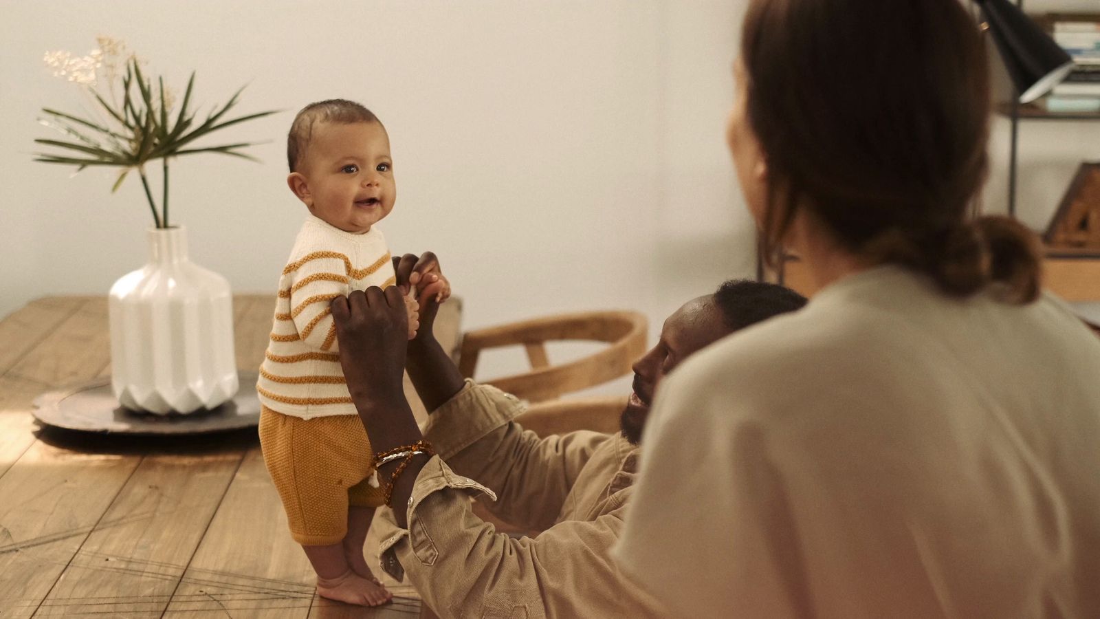 a woman holding a baby up to his face