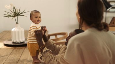 a woman holding a baby up to his face