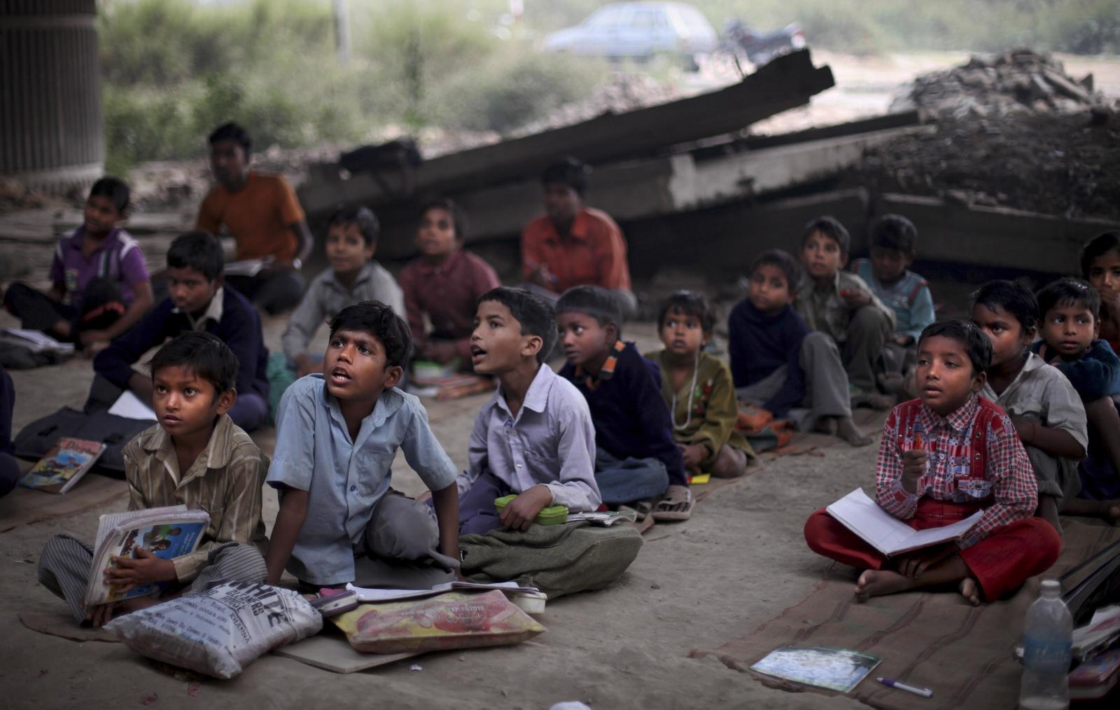 a group of children sitting on the ground