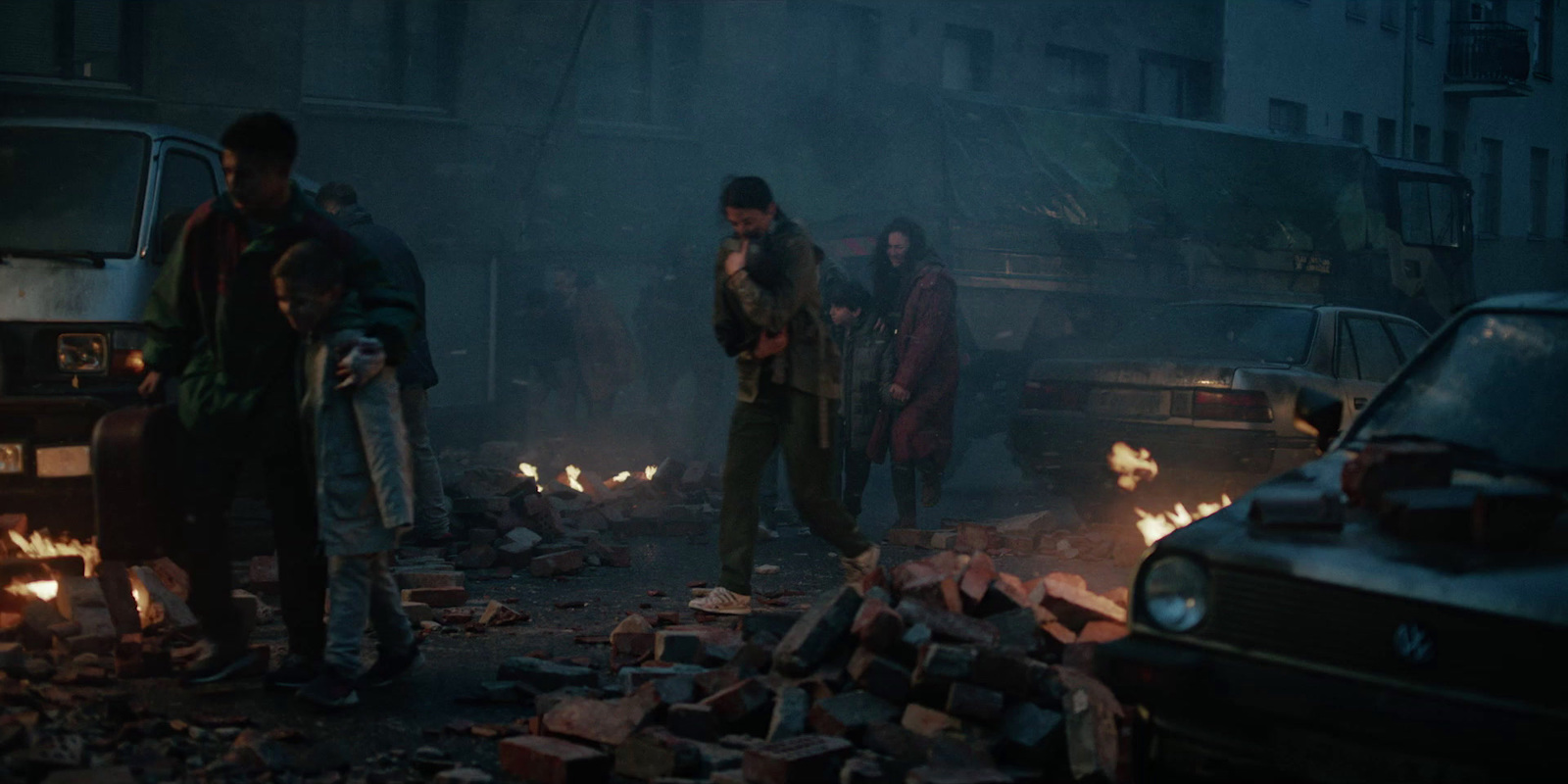 a group of people standing around a fire pit