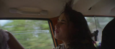 a woman sitting in the passenger seat of a car