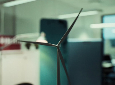 a wind turbine sitting in a room next to a computer