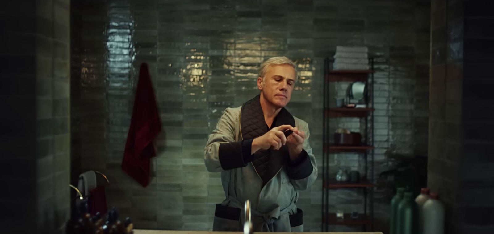 a man standing in front of a sink in a bathroom