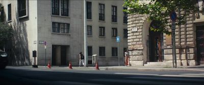 a street corner with a building in the background