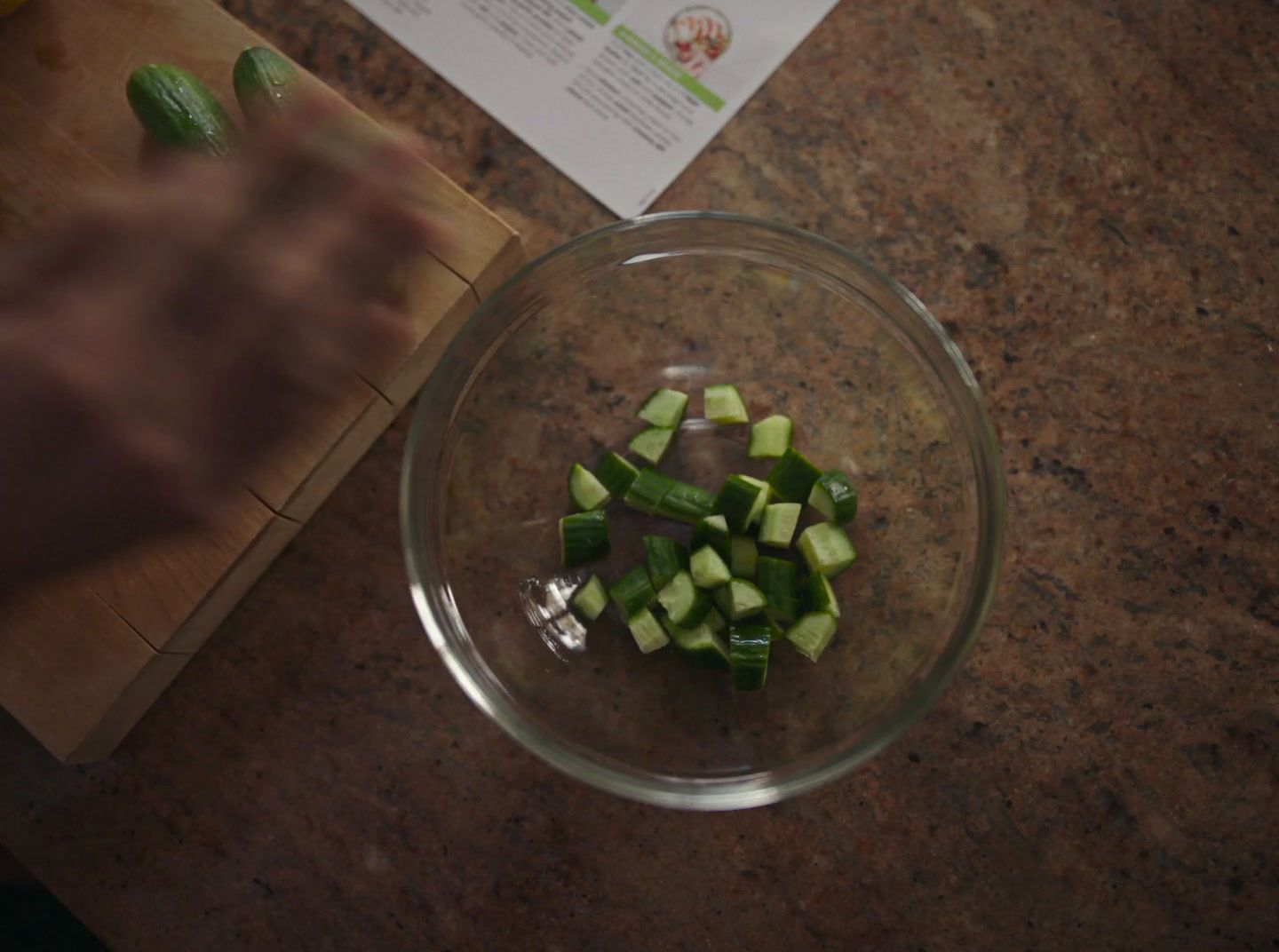 a glass bowl filled with chopped up green vegetables