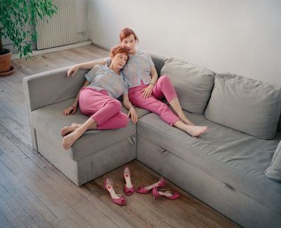 a couple of women sitting on top of a couch