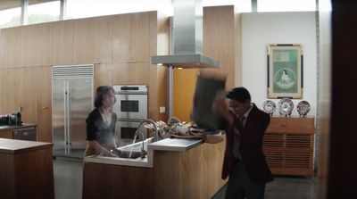 a man and a woman standing in a kitchen