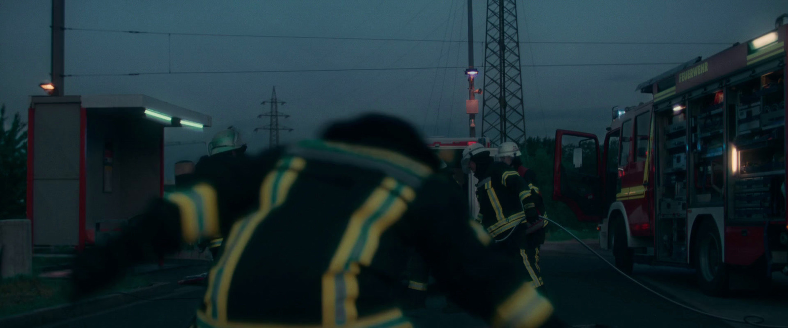 a group of fire fighters standing next to a fire truck