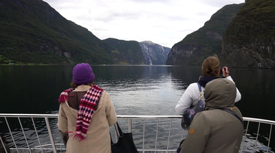 a group of people on a boat looking out over a body of water