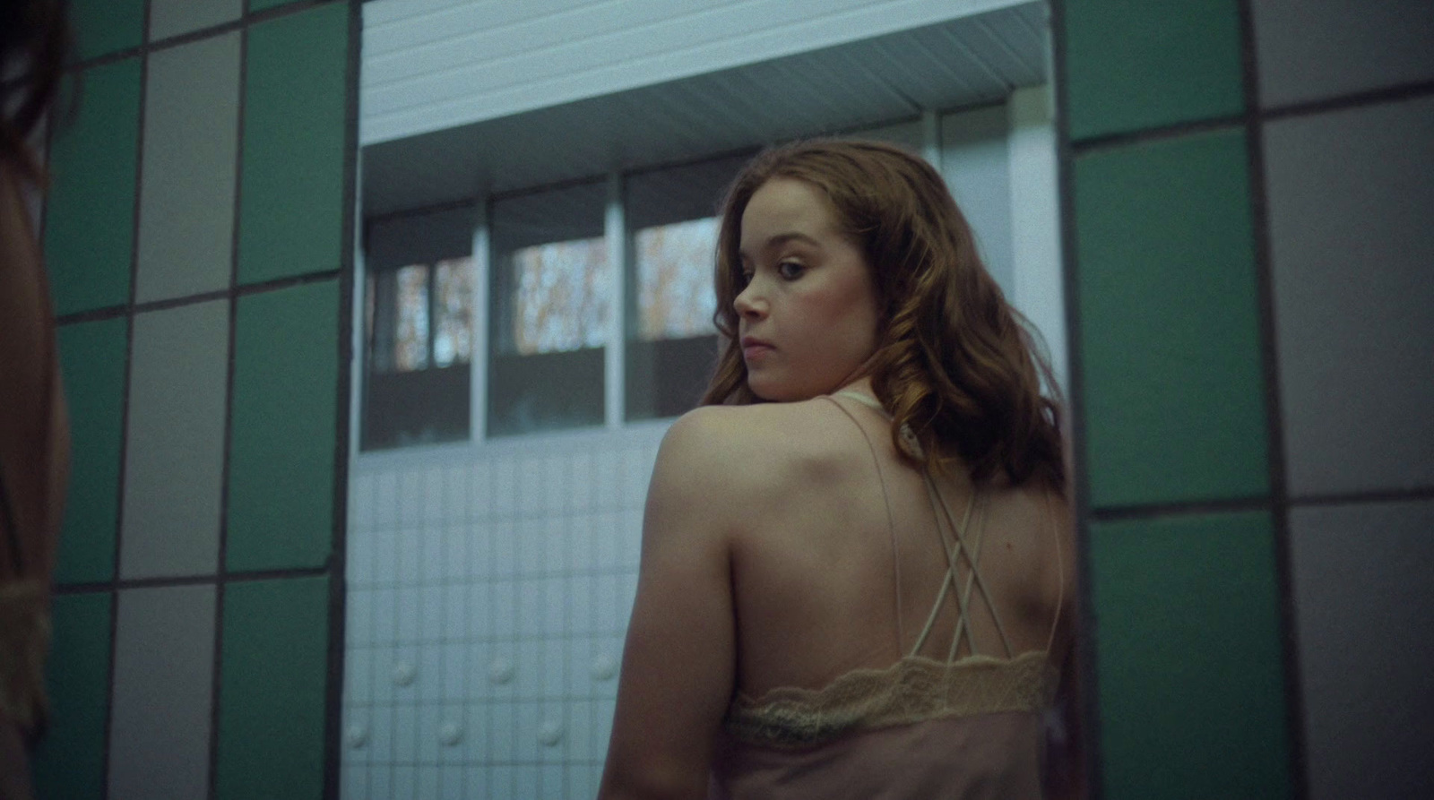 a woman standing in front of a mirror