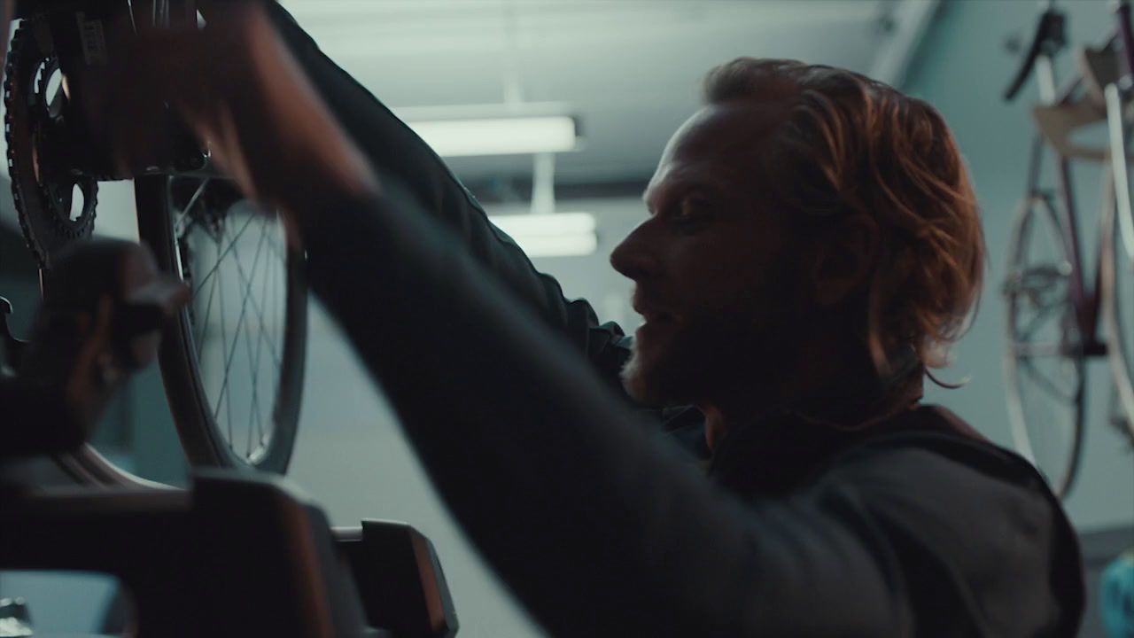 a man working on a bicycle in a garage