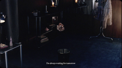 a dark room with a shelf and a lamp