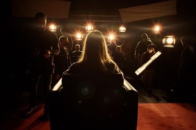 a group of people standing in a dark room