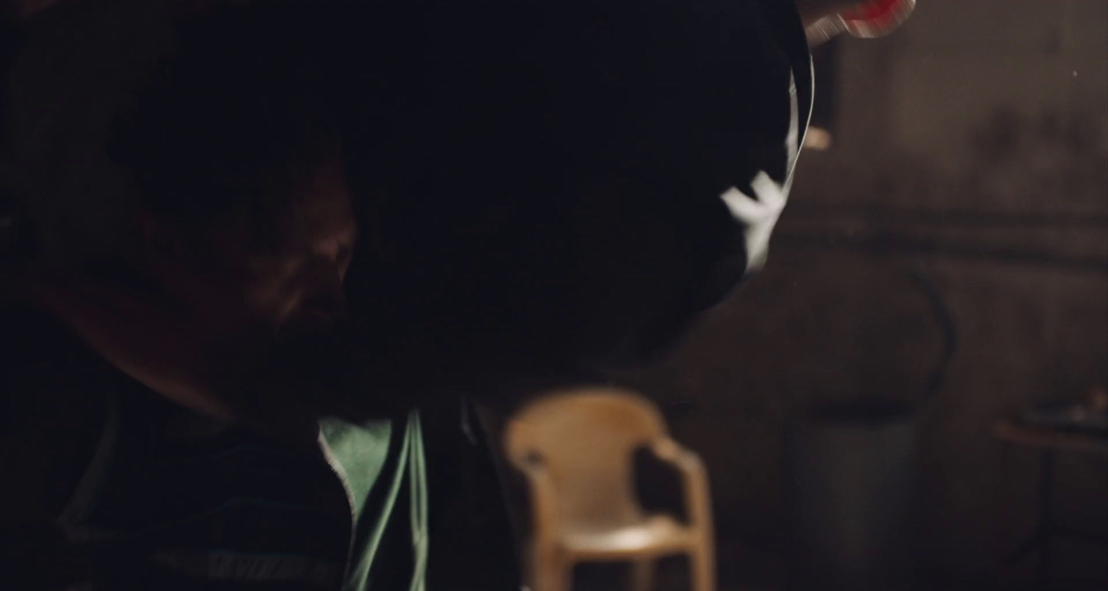 a man sitting in a chair in a dark room