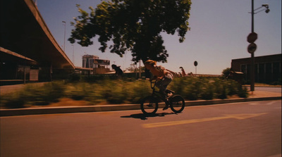 a man riding a bike down a street