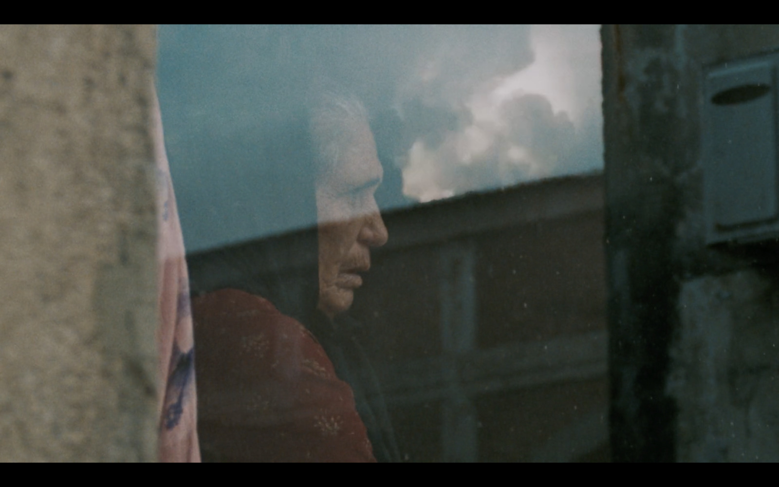 a man looking out of a window at a building