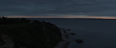 a dark sky over a body of water