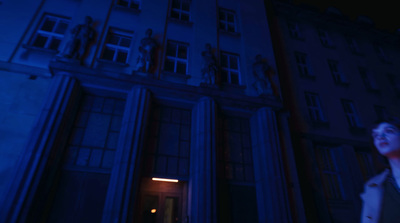 a woman standing in front of a tall building