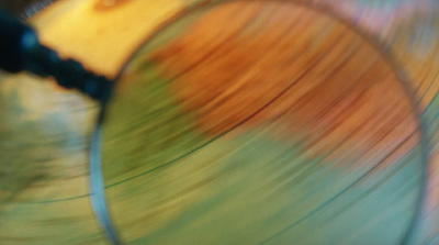 a close up of a magnifying glass with a blurry background