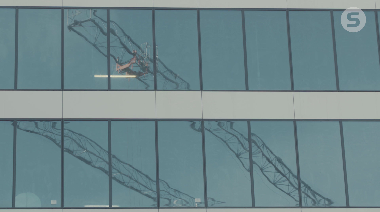 an airplane is flying in the sky through the windows of a building