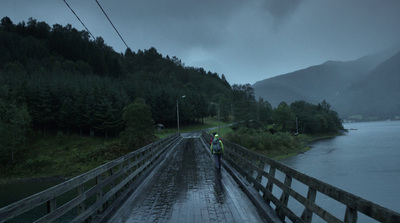 a couple of people that are walking across a bridge