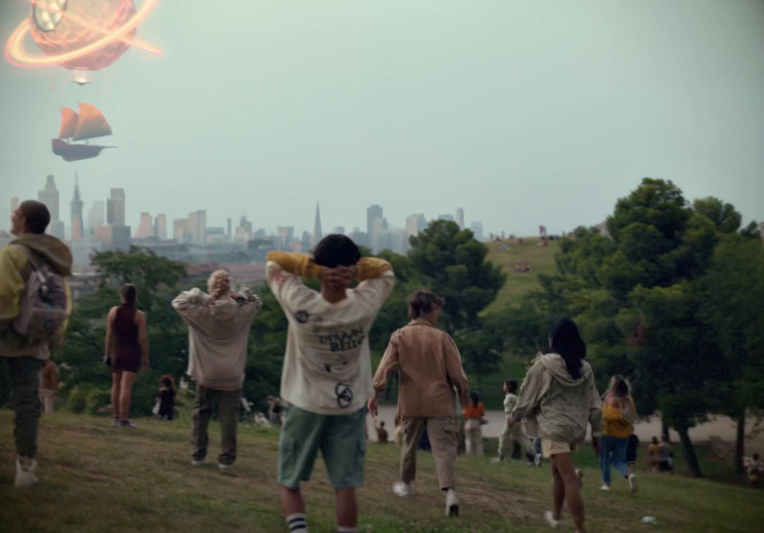 a group of people flying a kite in a park