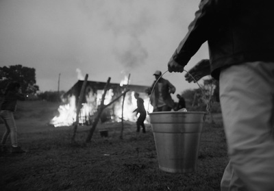 a group of people standing around a fire