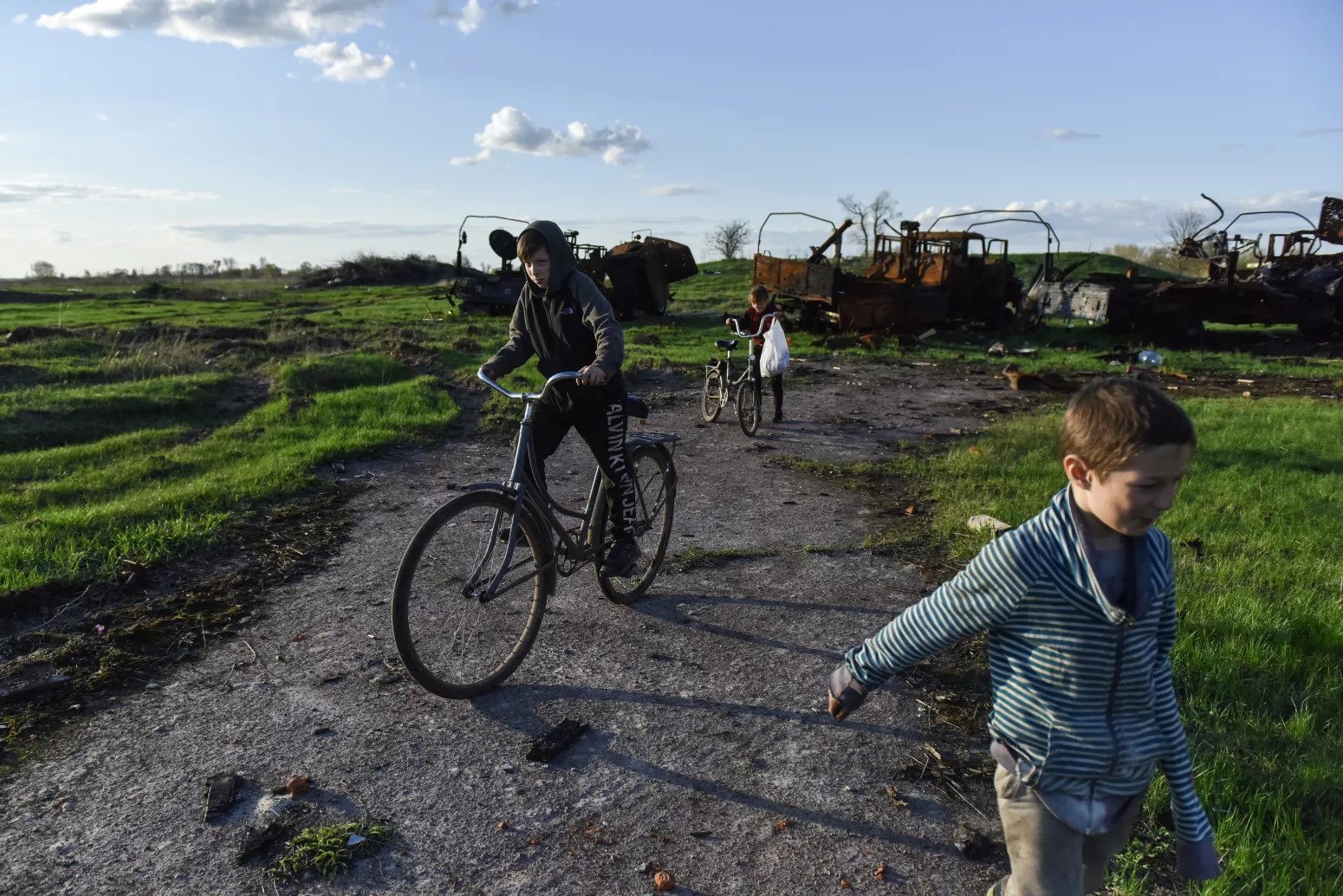 a man riding a bike next to a boy on a bike