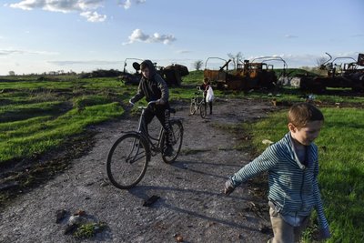 a man riding a bike next to a boy on a bike