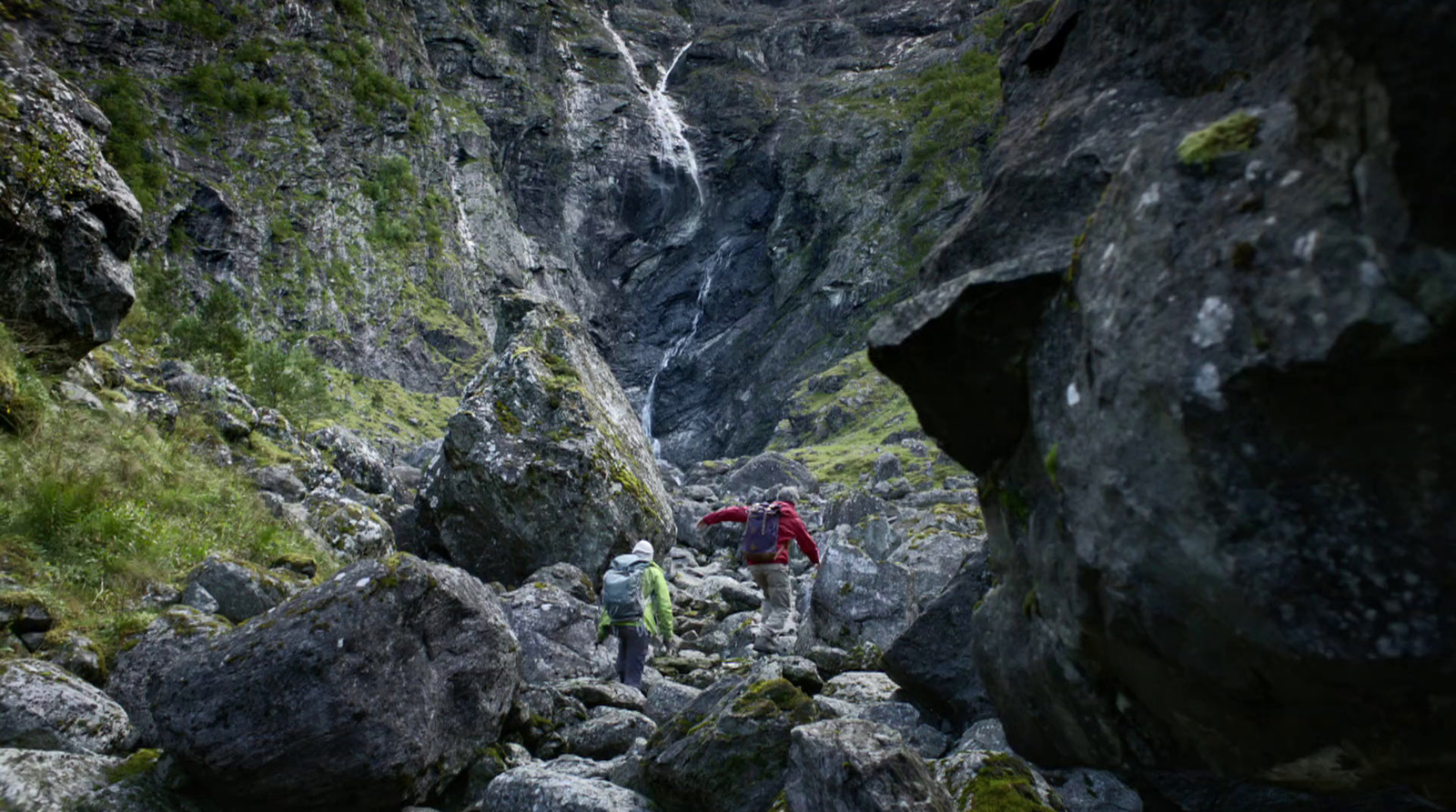 a group of people climbing up a rocky mountain