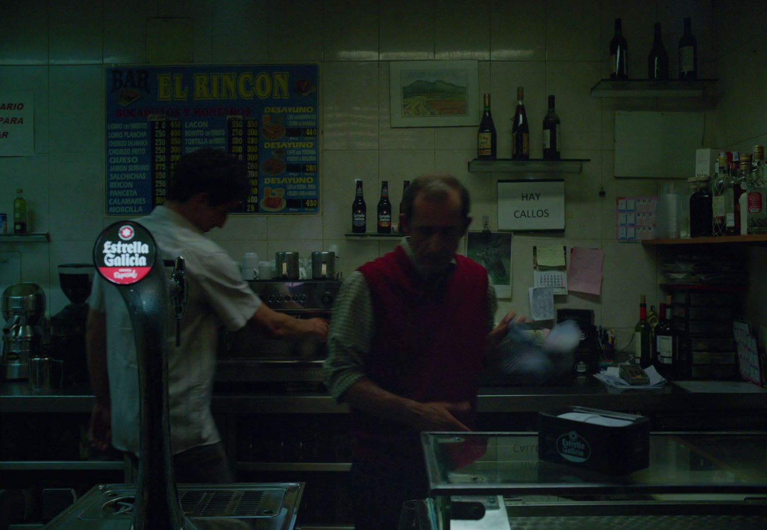 a couple of men standing in a kitchen next to each other