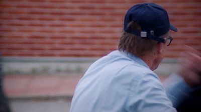 a man with a baseball cap and glasses on