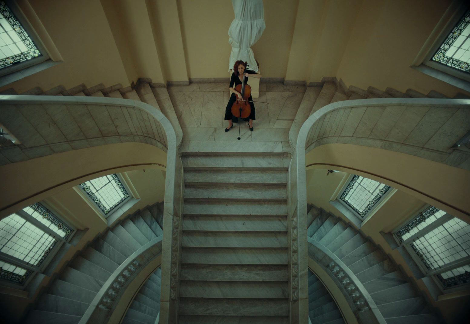 a woman sitting on top of a set of stairs