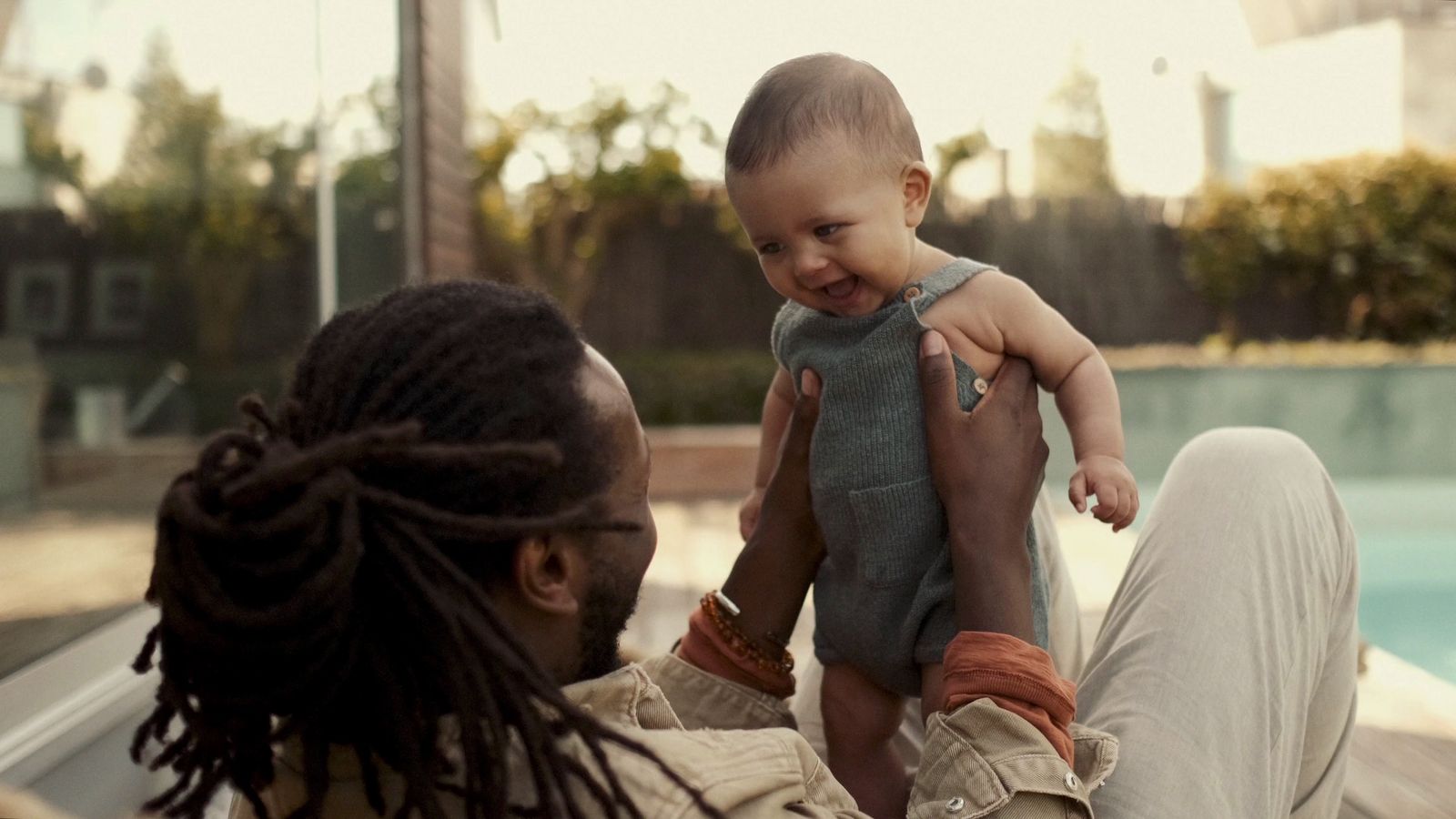 a woman holding a baby up to her face