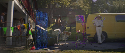 a group of people standing around a yellow van