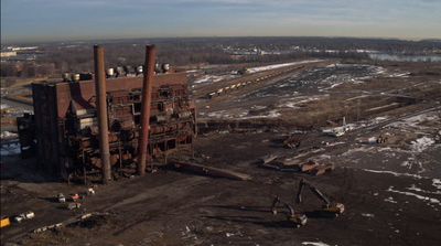 an old factory with a crane in the foreground