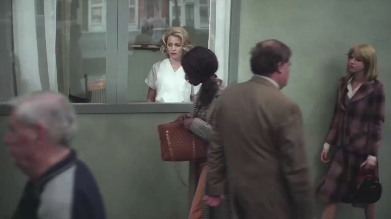 a group of people standing in front of a window