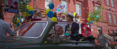 a group of people in a car with balloons and confetti